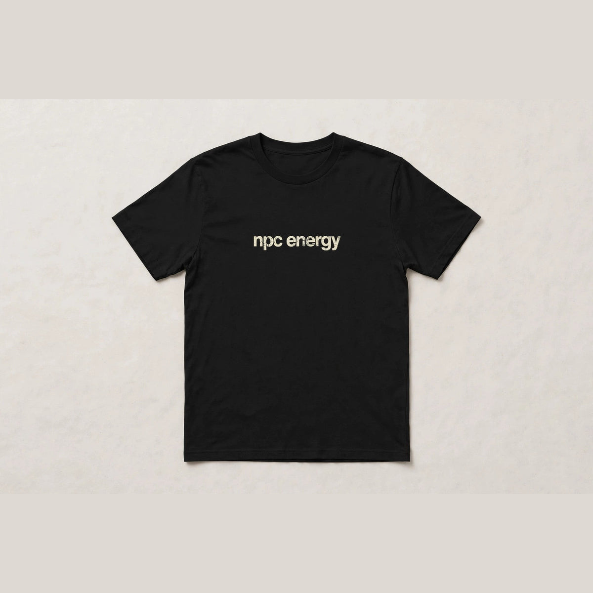 NPC Energy funny gamer slang t-shirt in Black - distressed cream lowercase text, Bella Canvas tee, flat lay front view, funny gaming humor shirt