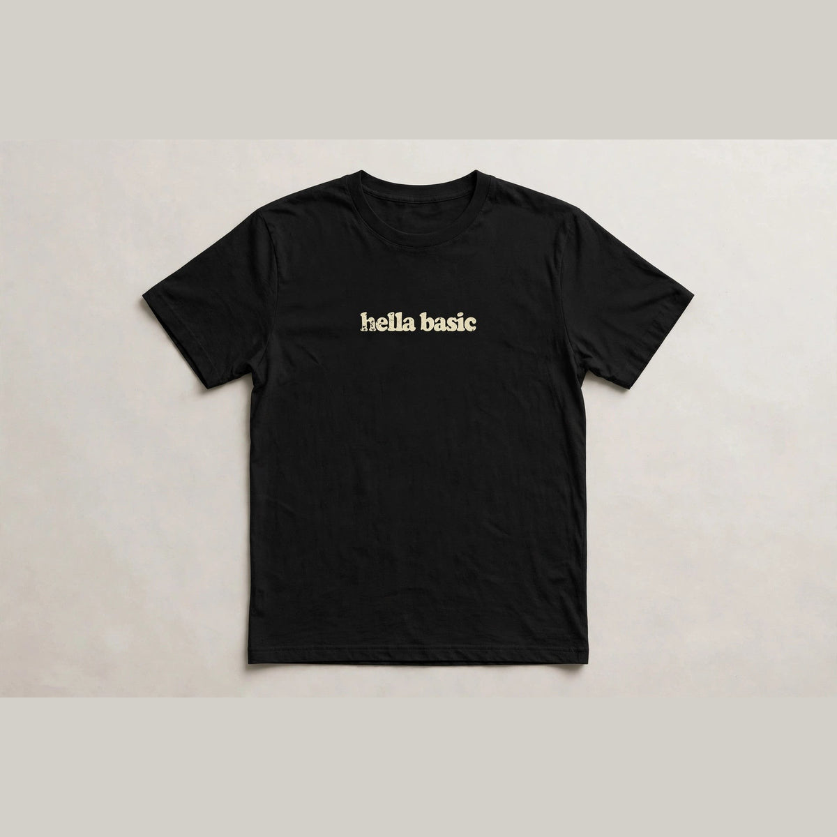 Hella Basic funny slang t-shirt in Black - distressed cream lowercase text, Bella Canvas tee, flat lay front view, funny sarcastic humor shirt