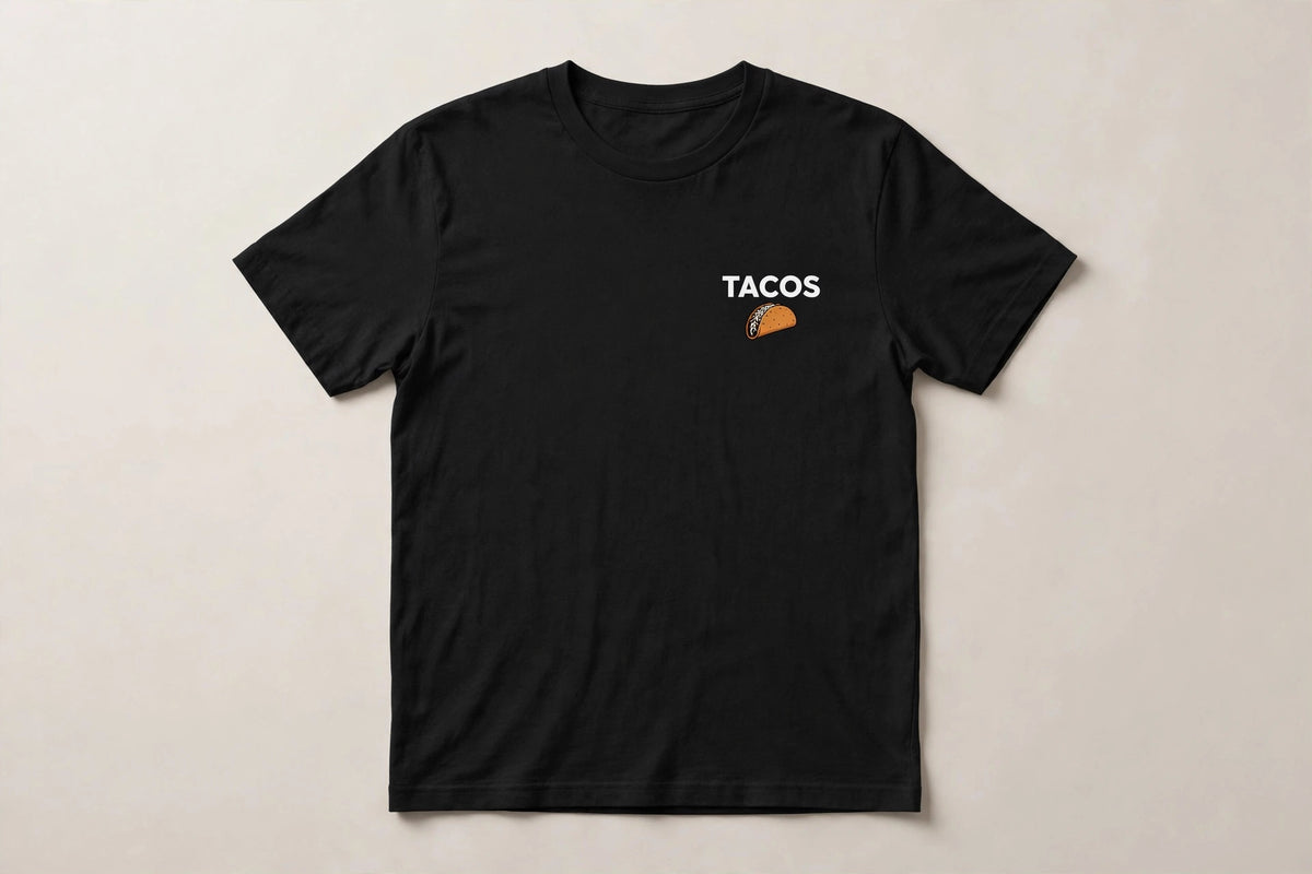 Tacos shirt front - TACOS white chest print with small taco icon below on black Bella Canvas tee flat lay