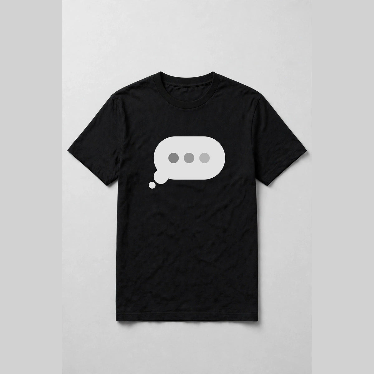 Typing dots shirt front print - big typing bubble with three dots front and center on black Bella Canvas tee, shirt only flat lay