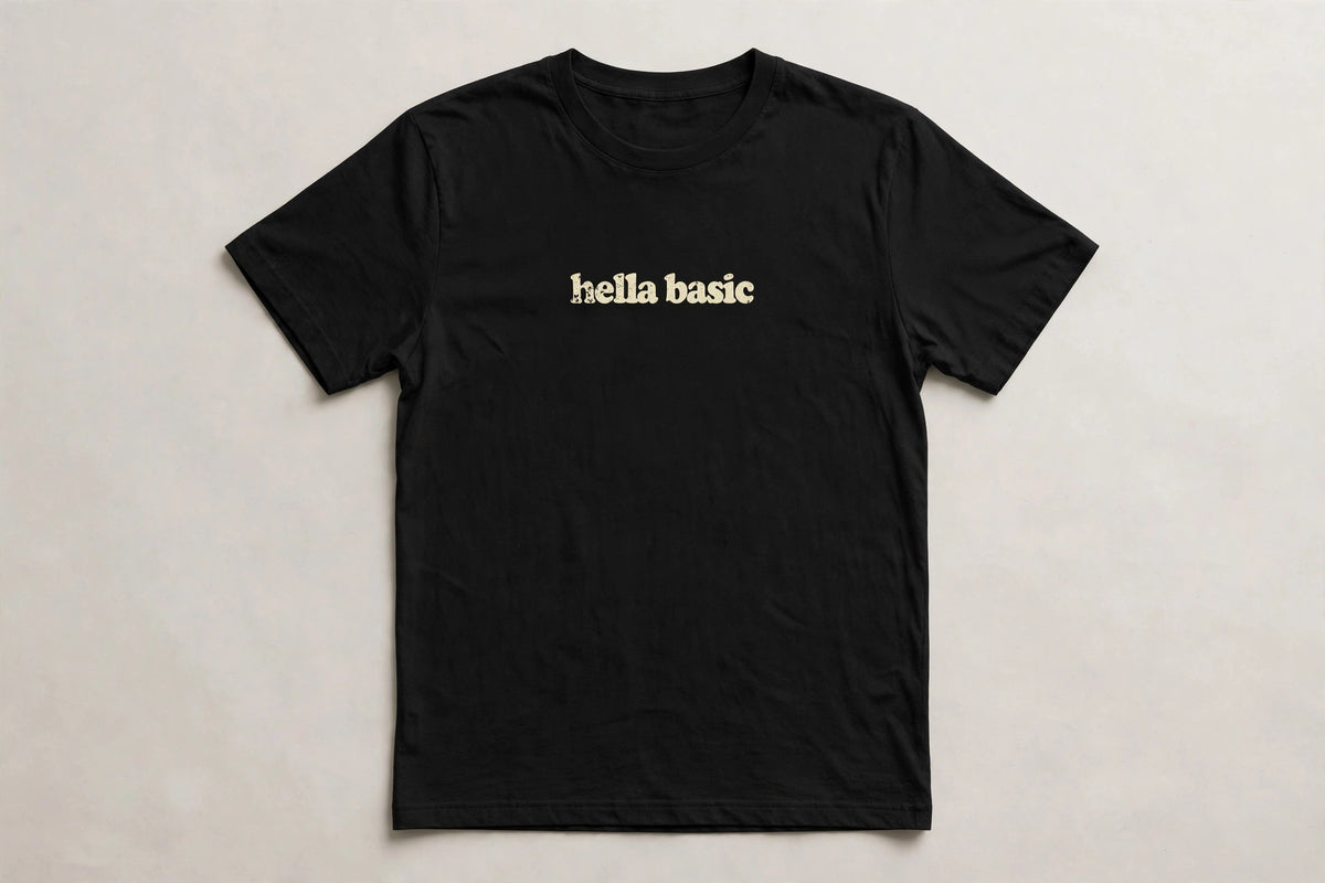 Hella Basic funny slang t-shirt in Black - distressed cream lowercase text, Bella Canvas tee, flat lay front view, funny sarcastic humor shirt