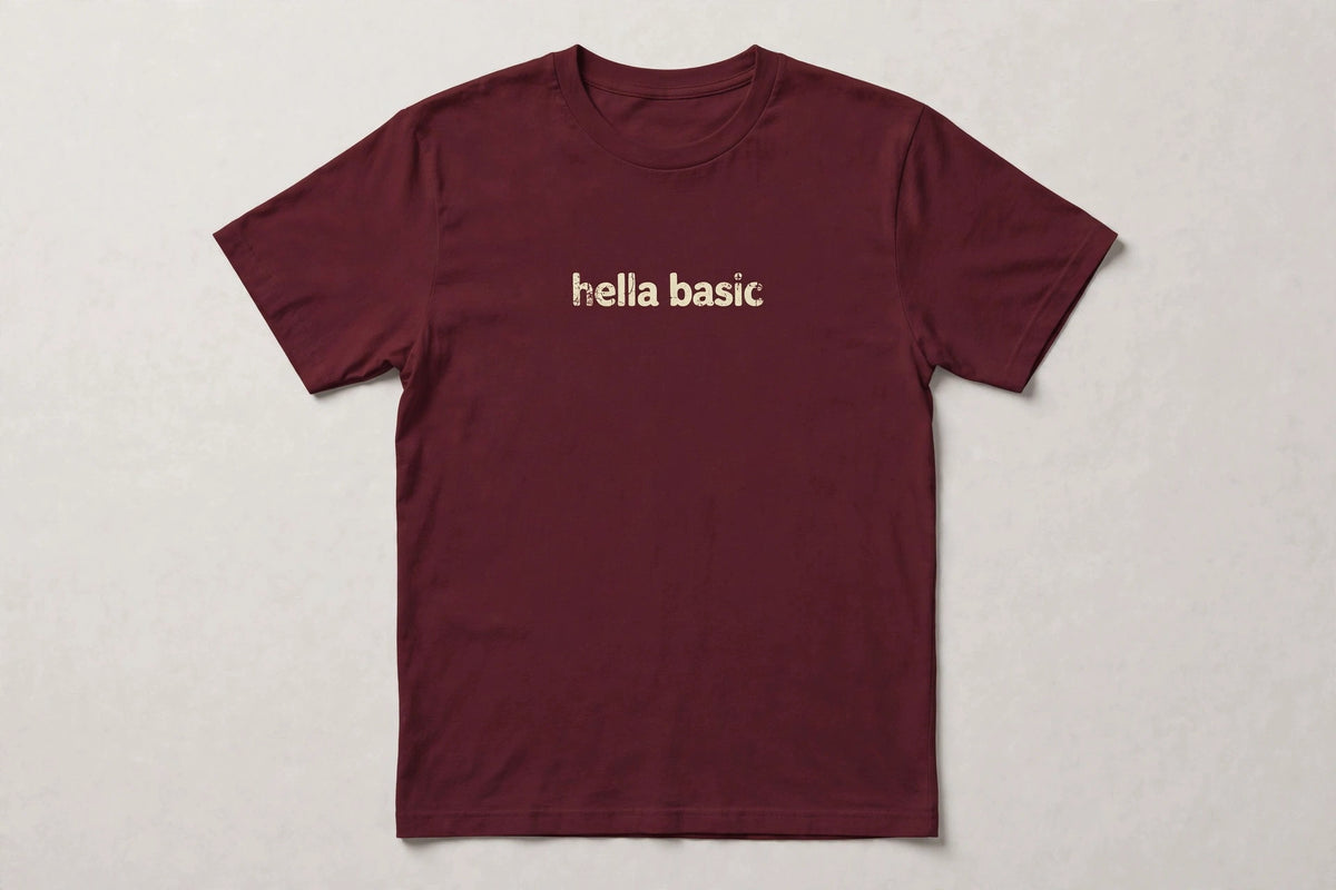 Hella Basic funny slang t-shirt in Maroon - distressed cream lowercase text, Bella Canvas tee, flat lay front view, funny sarcastic humor shirt
