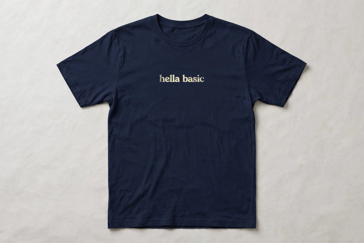 Hella Basic funny slang t-shirt in Navy - distressed cream lowercase text, Bella Canvas tee, flat lay front view, funny sarcastic humor shirt