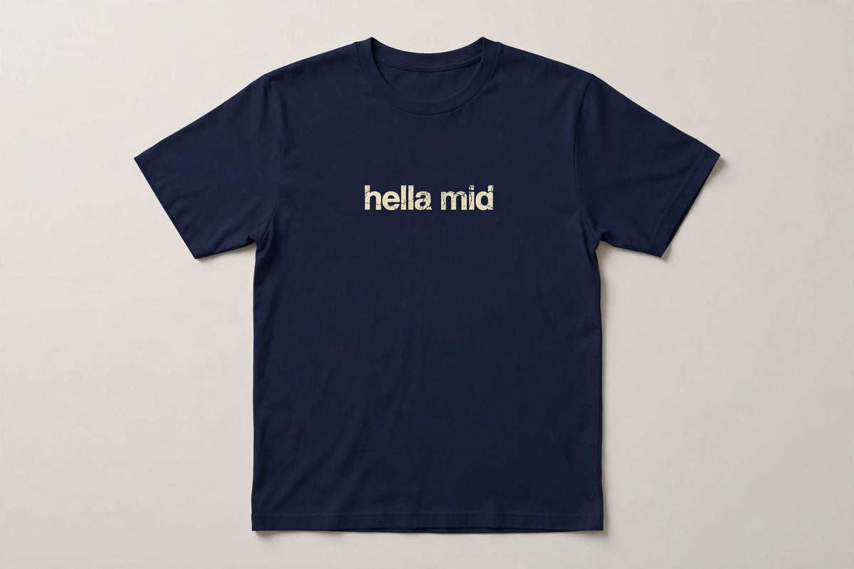 Hella Mid funny slang t-shirt in Navy - distressed cream lowercase text, Bella Canvas tee, flat lay front view, funny gen z humor shirt
