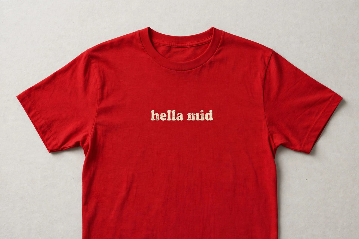 Hella Mid funny slang t-shirt in Red - distressed cream lowercase text, Bella Canvas tee, flat lay front view, funny gen z humor shirt