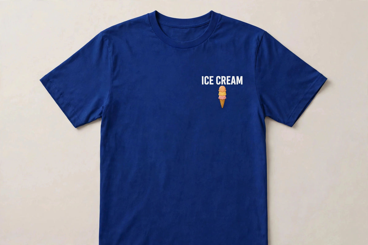 Ice cream shirt front - ICE CREAM white chest print with small triple scoop cone icon below on blue Bella Canvas tee flat lay