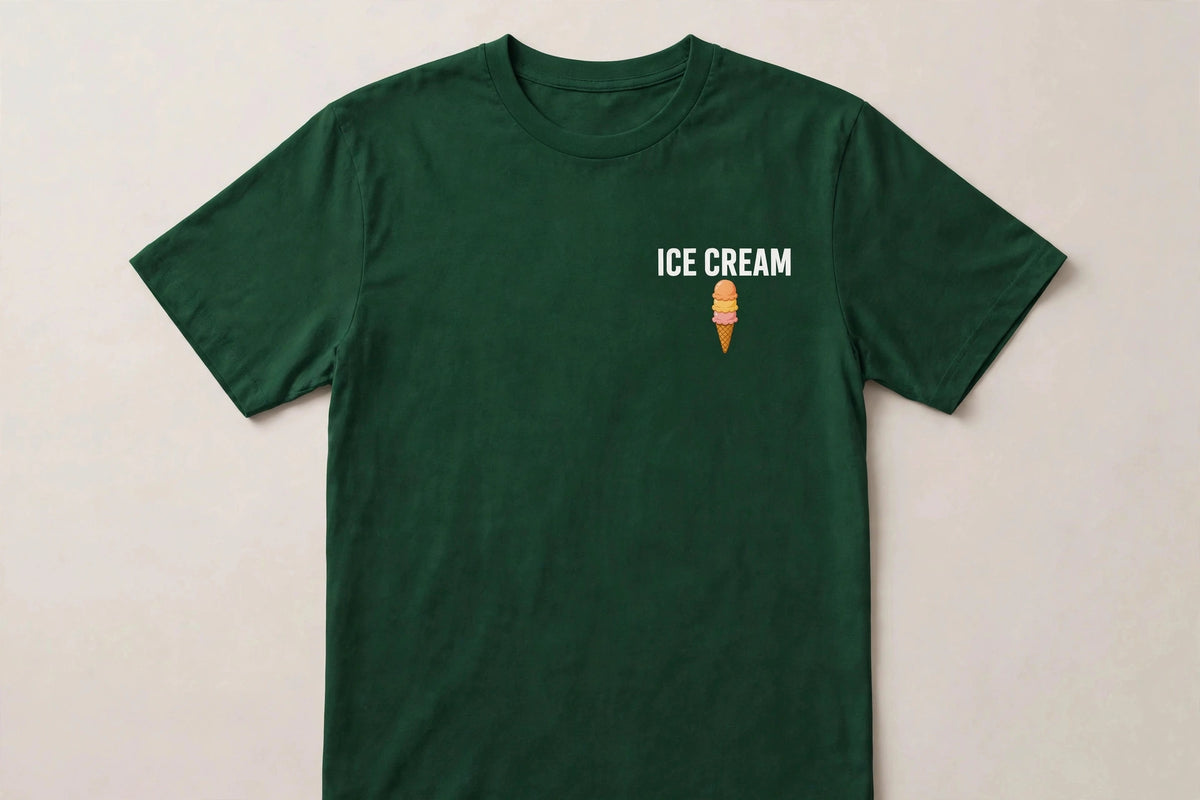 Ice cream shirt front - ICE CREAM white chest print with small triple scoop cone icon below on green Bella Canvas tee flat lay