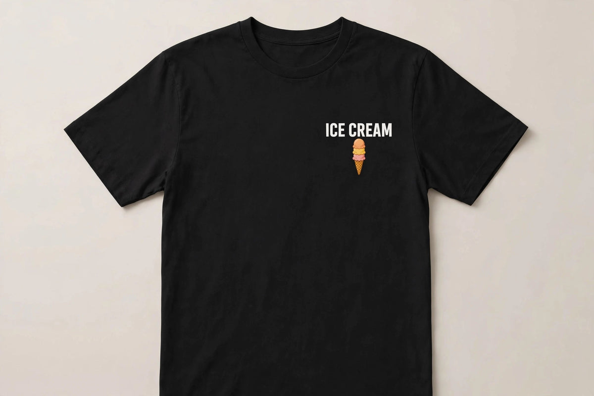 Ice cream shirt front - ICE CREAM white chest print with small triple scoop cone icon below on black Bella Canvas tee flat lay