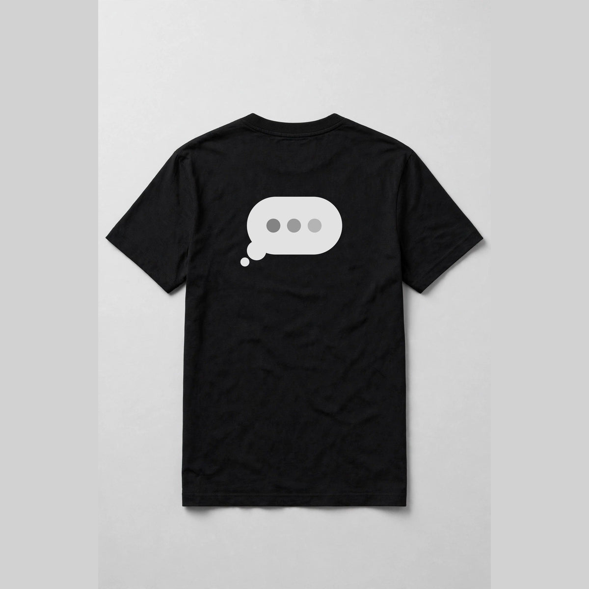 Typing dots shirt back print - typing bubble with three dots back print on black Bella Canvas tee, shirt only flat lay