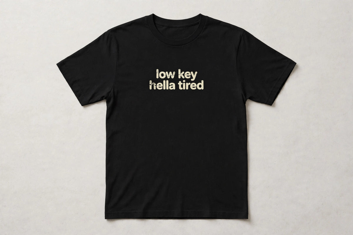 Low Key Hella Tired funny slang t-shirt in Black - distressed cream lowercase text, Bella Canvas tee, flat lay front view, funny tired humor shirt