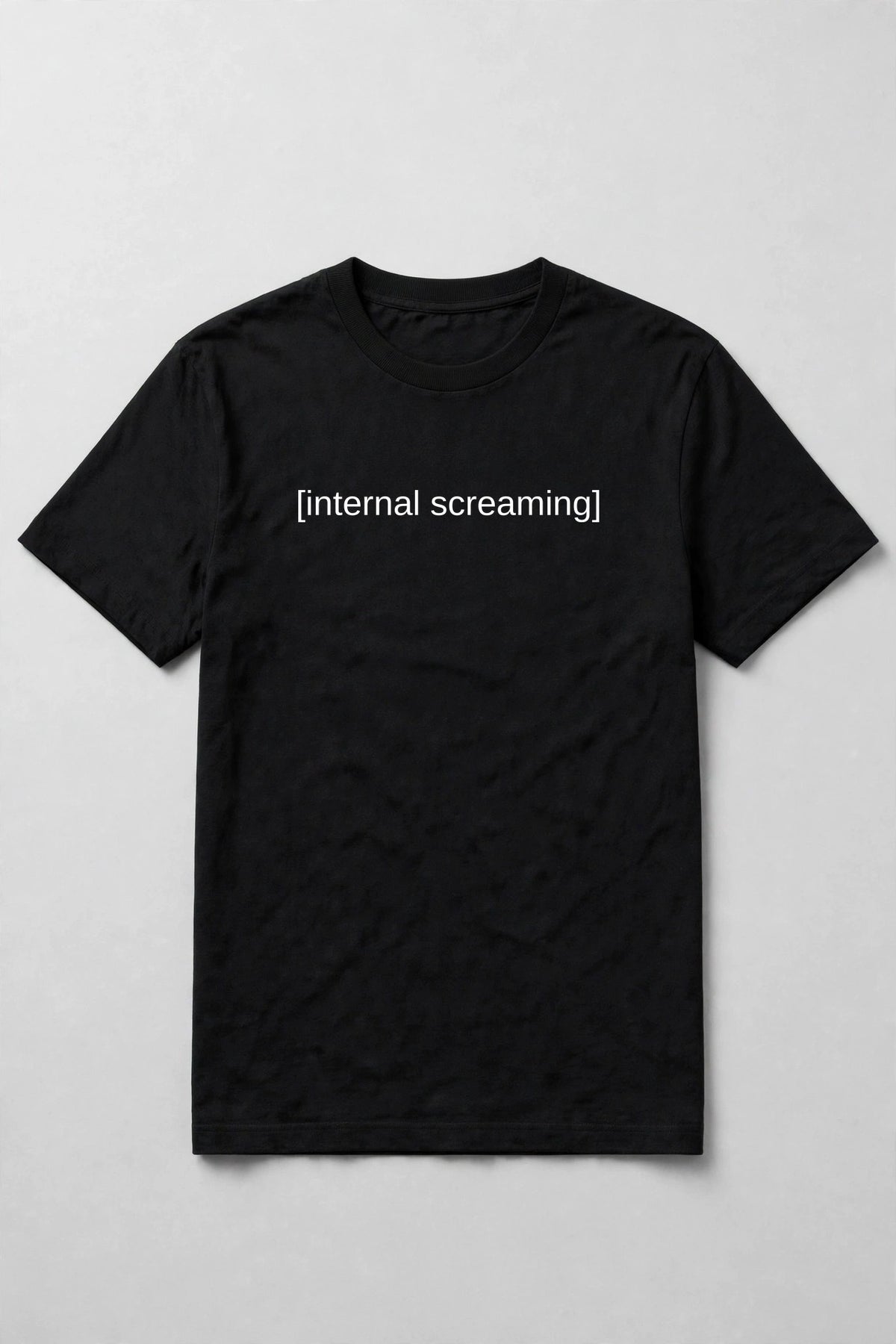 Black t-shirt flat lay with white subtitle text [internal screaming] printed across the chest